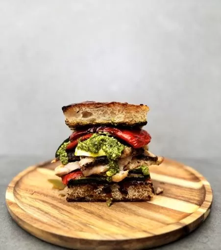 A delicious chicken sanwich using focaccia bread and Herb Fed chicken, topped with mozzarella and grilled vegetables | Herb Fed Poultry