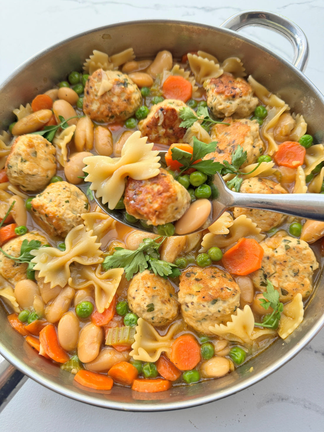 Herb Fed golden chicken stock with Spring Veg & Chicken balls