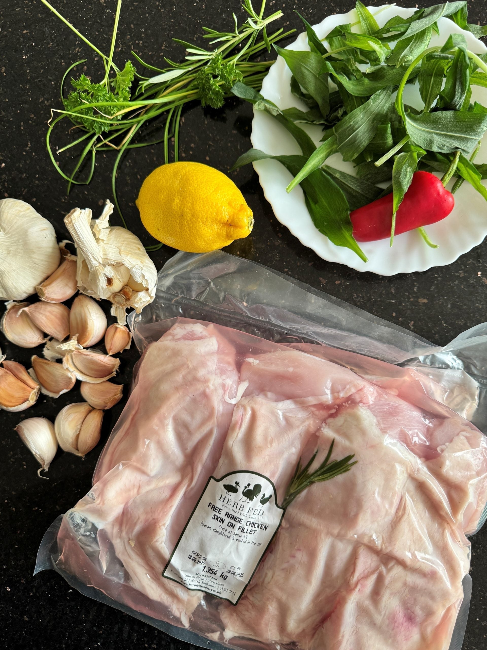 chicken ready for the freezer on a table with salad items | Herb Fed Poultry