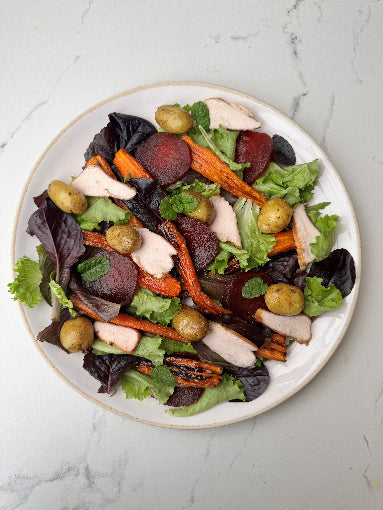 A plate of Herb Fed smoked chicken salad with carrots, beetroots and salad leaves | Herd Fed Poultry