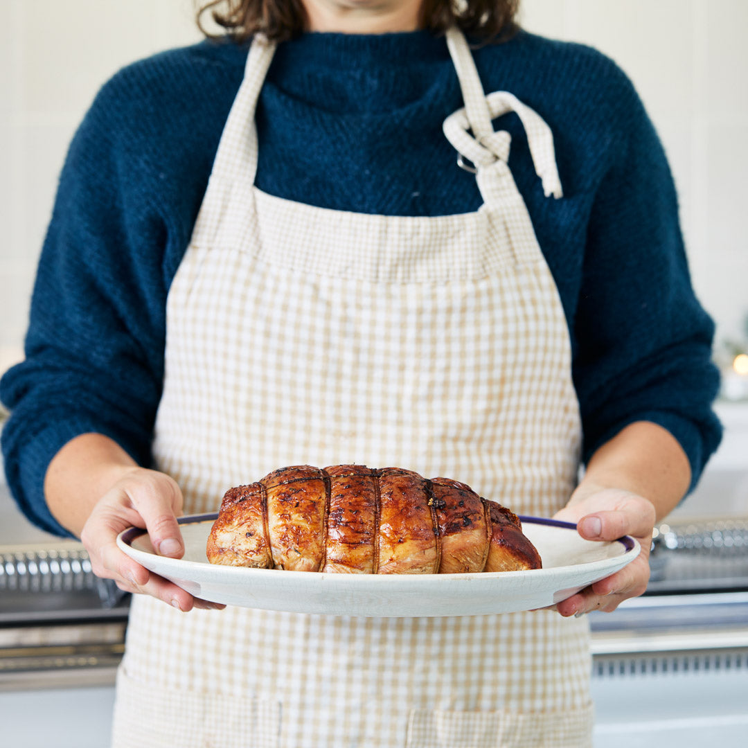 Someone holding a cooked turkey joint | Herb Fed Poultry