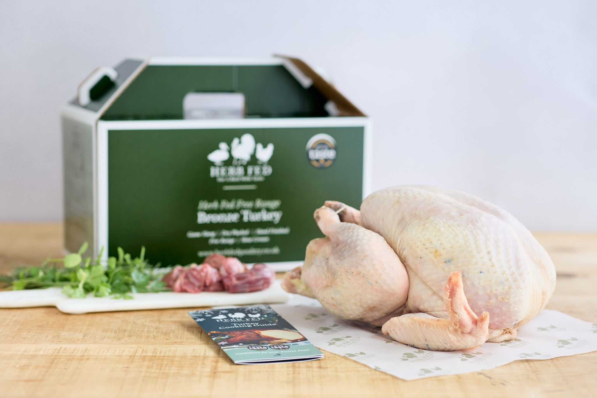 An uncooked turkey beside a box to package it in | Herb Fed Poultry
