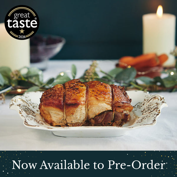 A roasted herb fed turkey breast and leg joint served on a white decorative plate, set on a table with candles, greenery, and carrots in the background. A black 'great taste 2026' badge appears in the top left, and a banner at the bottom reads 'Now Available to Pre-Order'.