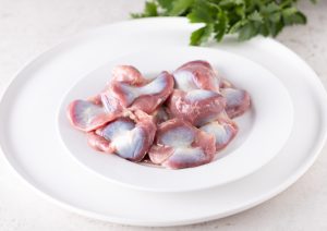 chicken giblets on a plate prior to cooking